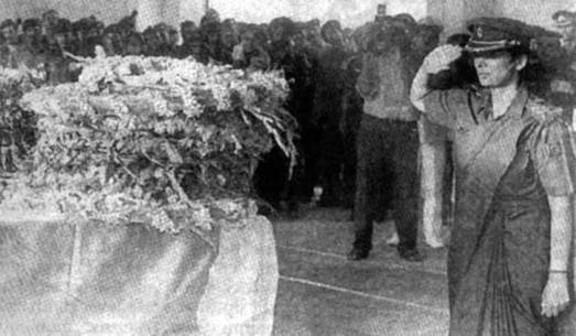 salutes the tricolour-draped coffin of her husband
